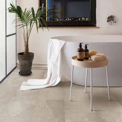 minimalist bathroom with palm tree, tub, and beige tiles